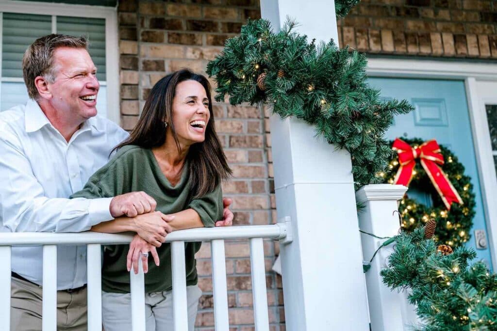 happy homeowners after hiring professional christmas light installers